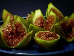 MS Shot of green figs rotate on blue plate / Estepona,Espana, Malaga, Spain   Stock Footage
