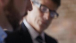 Financial advisor points out numbers from business report to restaurant owner Stock Footage