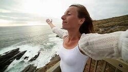 Young woman arms outstretched towards the sea Stock Footage