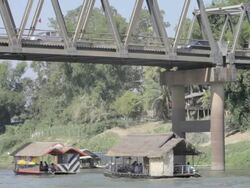 WS boats going under bridge / Tha Ngon, Laos Stock Footage