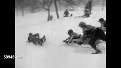 1950: WINTER SPORTS: Young child w/ ski poles skiing in snow, falling down. Group of children sledding down hill. Father sledding w/ child. Multi-person sled moving down hill. Instructional Video