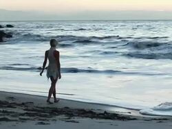 MS Ballerina dancer in white swan costume dancing on beach beside ocean at sun rises / Montezuma, Nicoya Peninsula, Costa Rica Stock Footage
