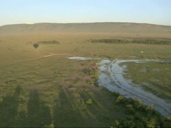 Aerial flooded river and grassy African landscape, Kenya, Africa (With audio of hot air balloon) Stock Footage