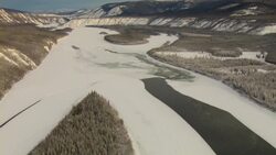Mountains rise above the frozen Yukon River. Stock Footage