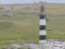 MS AERIAL ZO Shot of Isle de Sein lighthouse off Le Conquet / Brittany, France Stock Footage