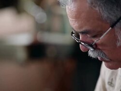 CU TD boot maker using tool to stretch leather and place tacks in sole of cowboy boot Stock Footage