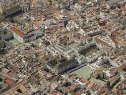 aerial view of historic city center of Cordoba with Cathedral-Mosque in center and Roman bridge spanning Guadalquivir river Stock Footage
