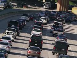 Long lens, overhead, huge traffic congestion on hot interstate highway. Stock Footage