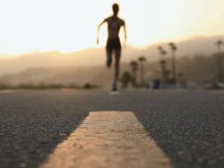 CU R/F Female runner running on bike path at sunset / Los Angeles, California, United States Stock Footage