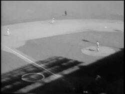 B/W 1956 high angle tilt up Don Larsen pitching a 'perfect game' with Gil Hodges batting, Mickey Mantle catching ball in outfield / Game 5 of the World Series Stock Footage