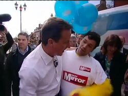 David Cameron on the campaign trail gets accosted by person dressed as a chicken. News Clip