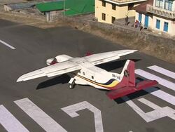 MS TS ZO Prop Aircraft Pilatus Porter taking off on small Runway of Lukla Airport near Khumbu Valley / Lukla, Khumbu Region, Nepal Stock Footage