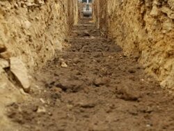 Excavator Digging a Geothermal Trench Stock Footage