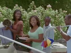 MS, PAN, parents with two teenage children (18-19) carrying belongings up steps to college dorm building, San Antonio, Texas, USA Stock Footage