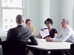 MS DS coworkers discussing project in office conference room Stock Footage
