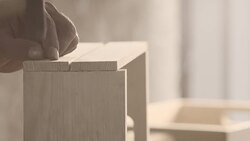 Carpenter hammering nail, creating wooden crate Stock Footage