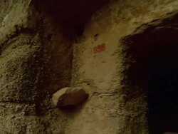 A shot panning from right to left of the many entrances of the Sutra Caves in China.  Stock Footage