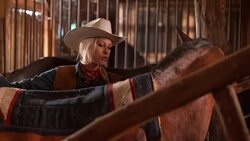 DS Female rancher putting a saddle blanket on her horse Stock Footage