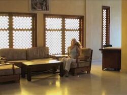 Arabian cozy atmosphere; woman sits on an armchair to relax Stock Footage