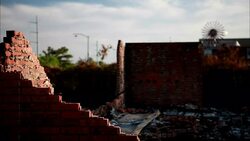 A weather vane spins on the ruins of a brick building on a cloudy day. Stock Footage