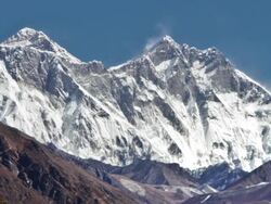 Time-lapse of Everest and surrounding peaks and people on a foreground trail. Cropped. Stock Footage