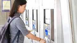 Woman buy the ticket by automatic ticket dispenser Stock Footage
