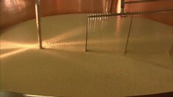 Whisks mix cheese in a copper vat. Stock Footage