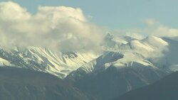 Clouds roil above snowy mountain peaks. Stock Footage