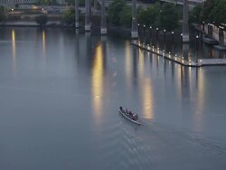 WS TU View of Row boat paddles up Willamette river Rose Garden Coliseum in Rose Quarter / Portland, Oregon, United States  Stock Footage