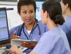 MS TD Medical Workers Updating and Discussing Patient Records in Hospital / Richmond, Virginia, USA Stock Footage