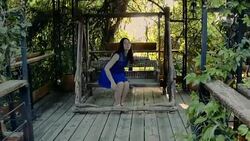 Young woman at old-fashioned wooden pavilion Stock Footage