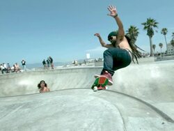 WS SLO MO Shot of two skateboarders doing front side air in skate park bowl and rail slide / Venice, California, United States Stock Footage