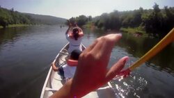 Girls paddle a canoe on a lake. Stock Footage