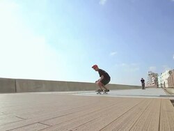 WS PAN Two men's skateboarding on side walk, showing skills / Chatan, Okinawa, Japan Stock Footage
