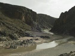 A quite river winds it's way through a mountain valley. Stock Footage