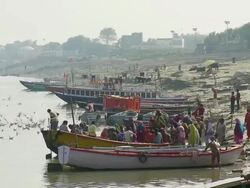 WS Pilgrims boarding in boat at Ganges river / Varanasi, Uttar Pradesh, India Stock Footage