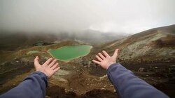 Personal perspective of woman arms stretch towards the Emerald lakes Stock Footage
