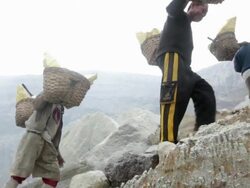 MS Miners climbing the Ijen volcano crater carrying solid sulfur / Ijen, Java, Indonesia Stock Footage