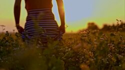SLO MO Woman walking through field of buckwheat Stock Footage