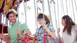 Father and son talking on amusement park ride Stock Footage