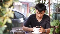 one man chatting by using smart phone in the cafe Stock Footage