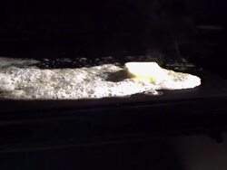 Medium, Locked Down - A pat of butter sizzles on a griddle / USA Stock Footage