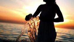 HD Super Slow-Mo: Silhouette Of A Woman Splashing Water Stock Footage