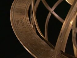 An  armillary sphere rotates in front of a black background. Stock Footage