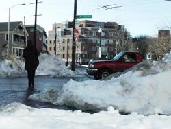 MS Shot of cars crossing on slushy city street with snow covered sidewalk / Boston, Massachusetts, United States Stock Footage
