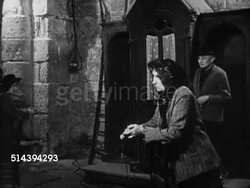 1950: BEAULIEU: DORDOGNE VALLEY: VS Facade of Beaulieu church building w/ sculptures depicting the Last Judgment. INT VS People at religious procession, priest at altar performing rituals, female playing piano. EXT WS Belcastel Church & valley. Instructional Video