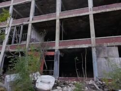 Exterior dolly view of abandoned auto assembly plant Stock Footage
