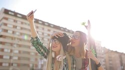 Hipster girlfriends taking a selfie in urban city context Stock Footage