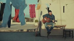 Hipster man playing acoustic guitar on the terrace Stock Footage