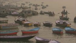 A flotilla of rowboats moor on the Ganges River in India. Stock Footage